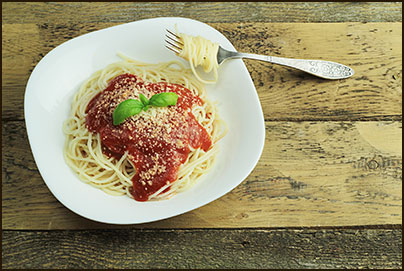 spaghetti on a white plate with a fork