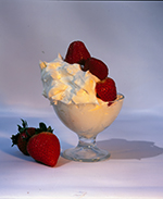 ice cream sundae in a glass dish with strawberries