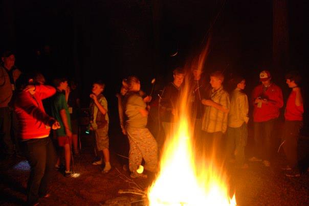 Students gather around a campfire