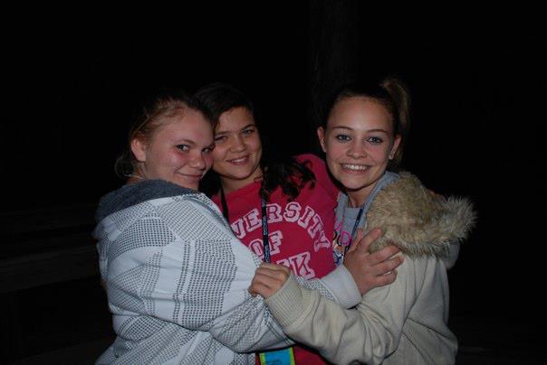 Three girls embracing and smiling