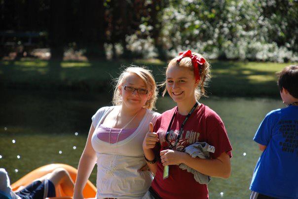 Two girls smiling near the lake