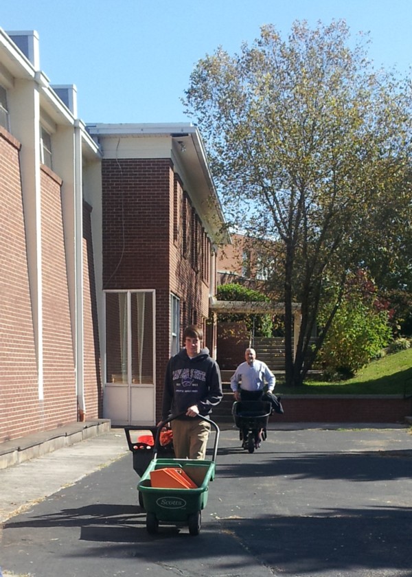 Jonathan Ray and his dad pushing wheelbarrows of supplies to the Pumpkin Patch.