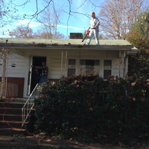 Blowing leaves off a residential roof