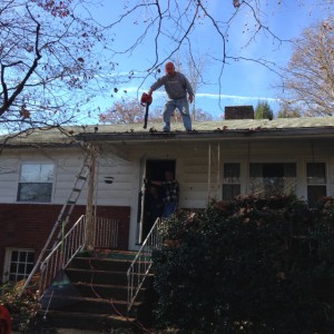 Blowing leaves off a residential roof