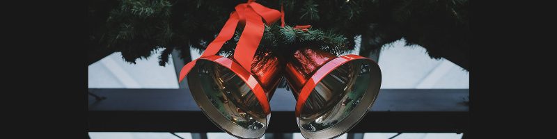 Two Christmas bells with red ribbon