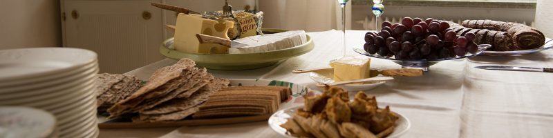 cheese, crackers, grapes on a holiday table