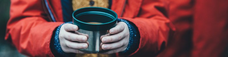 child holding a bowl of soup