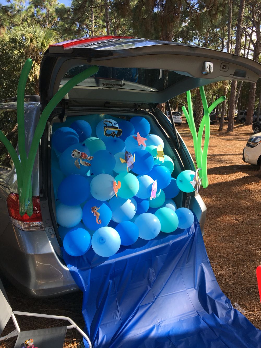 Trunk of a car, filled with blue balloons