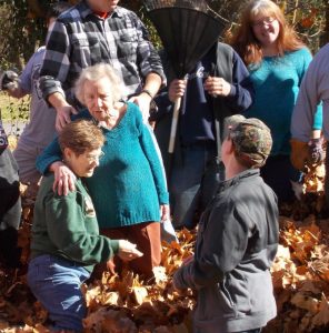 Group of people standing in a pile of leaves