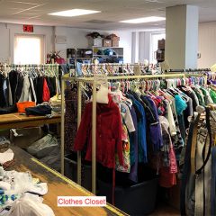 Racks of clothing in a large room