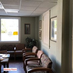 Agape Center waiting area. Chairs line the walls. There are children's toys on a table in the middle.