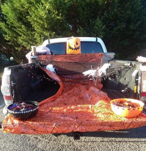 Truck decorated with orange spider web material and lights