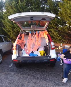 Car decorated with orange spider webs