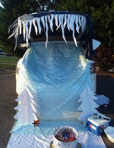 Car decorated with poster board ice cicles, white trees, and shimmering white fabric