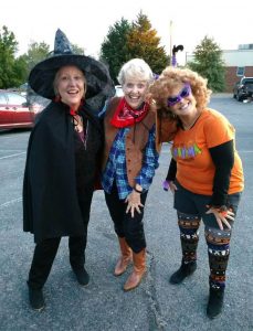 Halloween witch, cowgirl, and lady with purple cat glasses