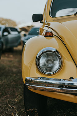 front of yellow Volkswagen Beetle