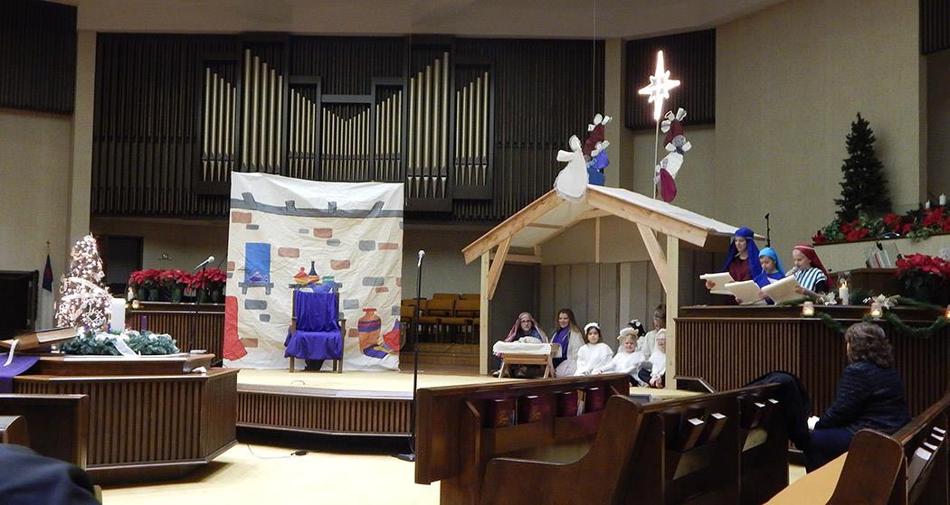 Nativity pageant scene with creche, star, and throne