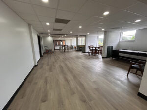 Large area with dining tables, sofas, and a pool table